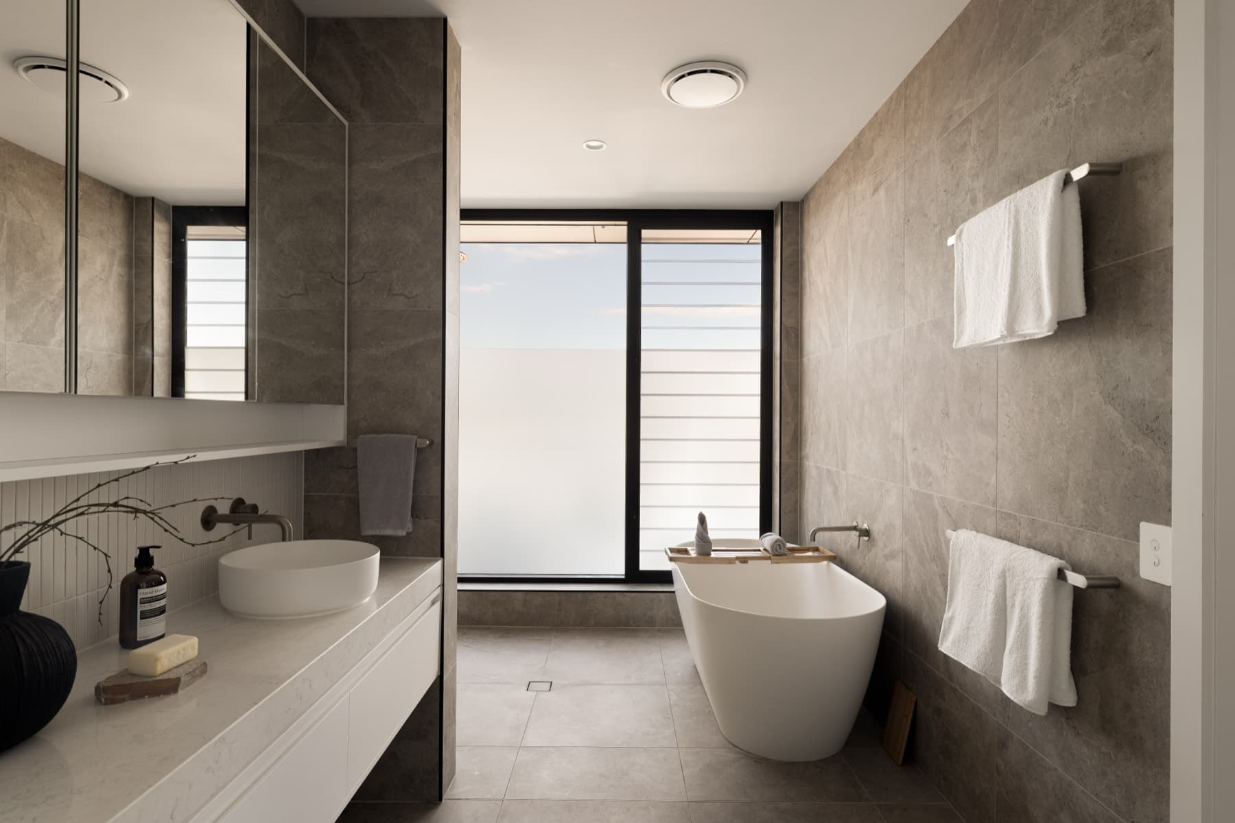 Ensuite with freestanding bath and stone finishes