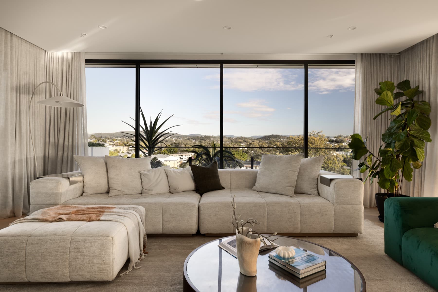 Living room with floor to ceiling windows and city outlook